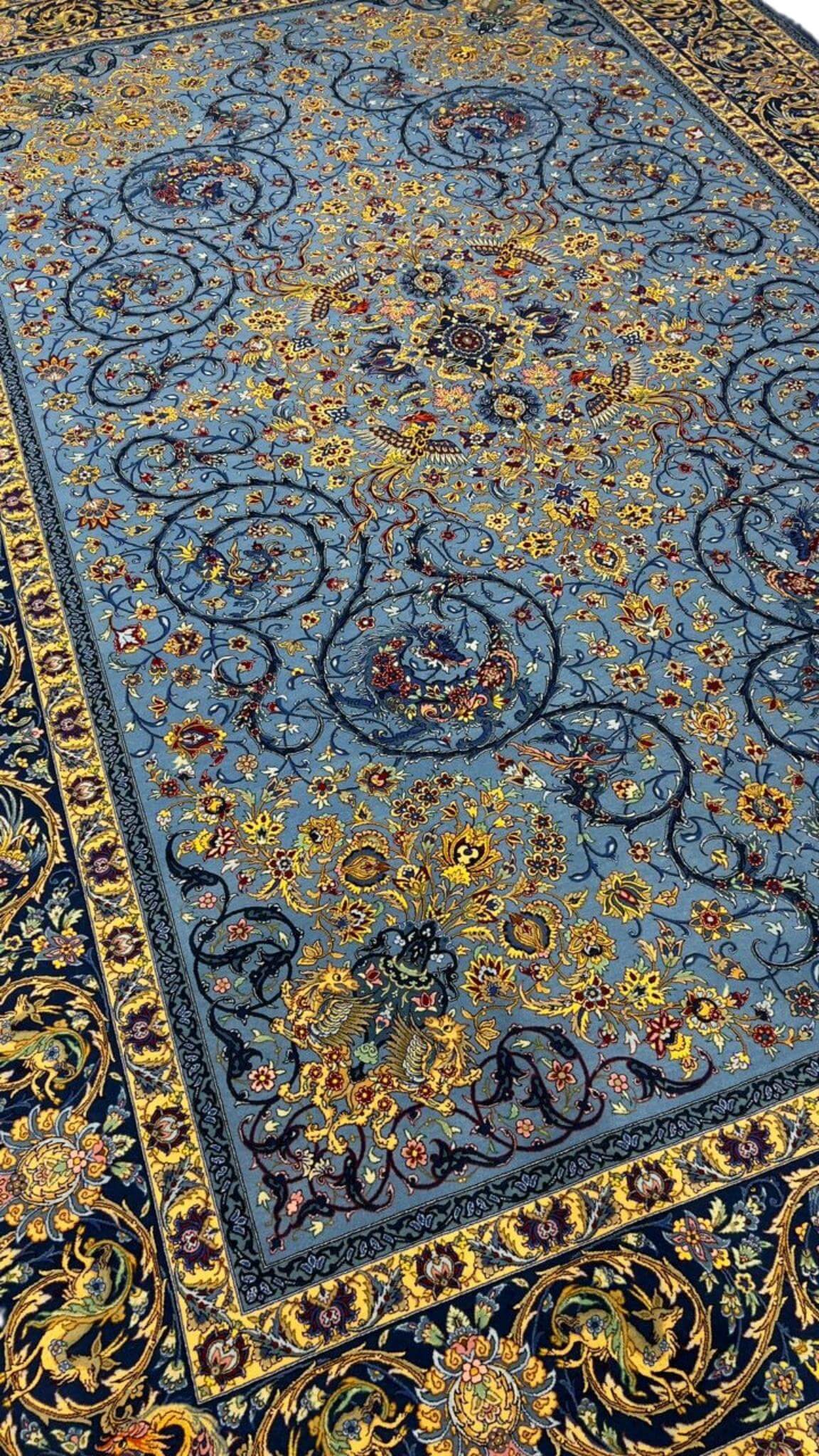 Blue Persian rug with intricate floral and vine patterns, hand-knotted by Mirzaie
